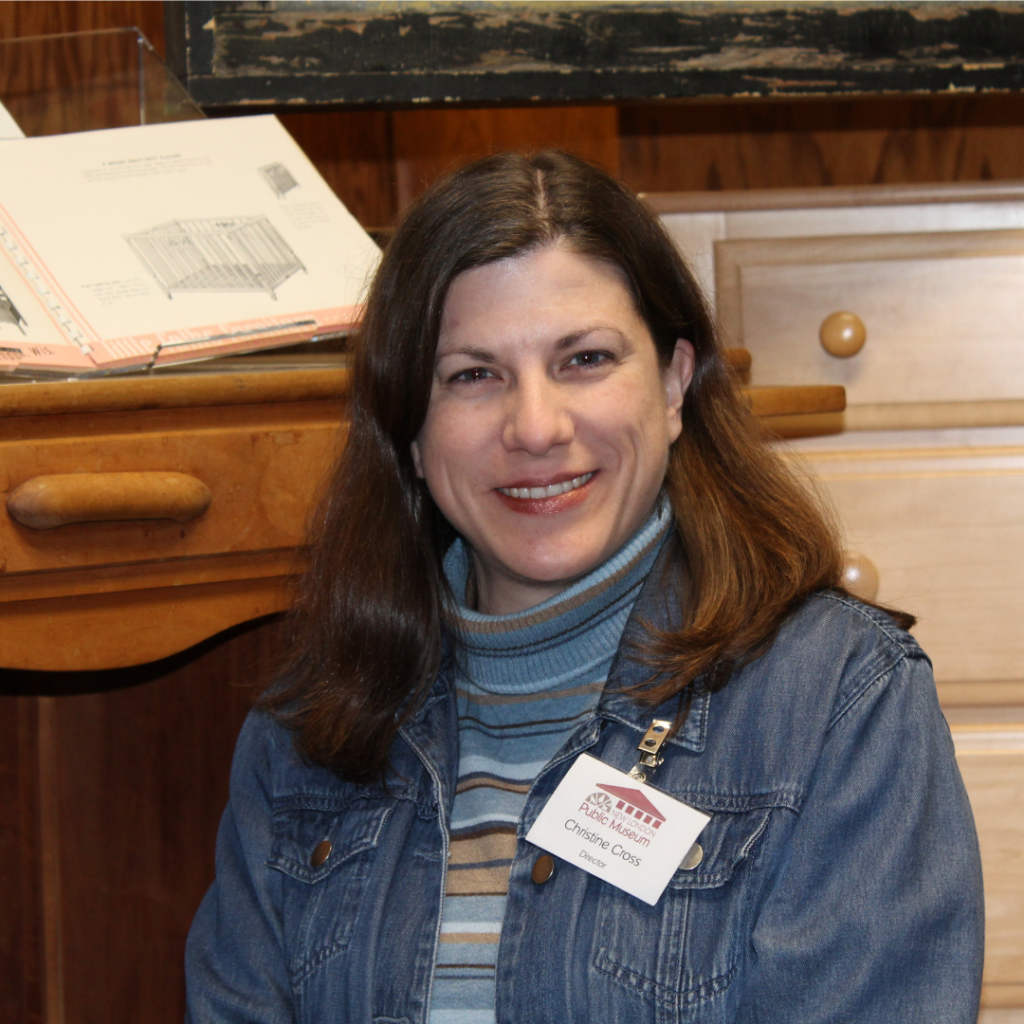 Person seated in front of wooden furniture