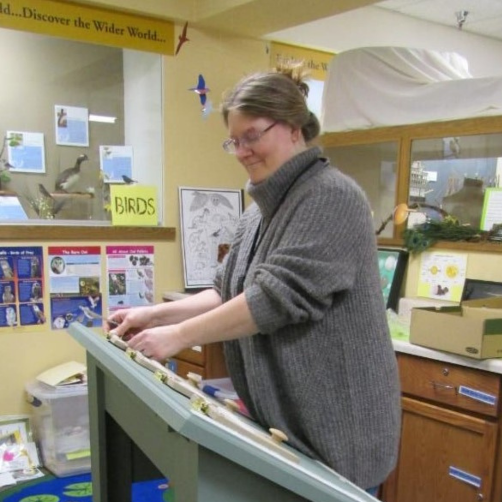 Person standing next wooden frame